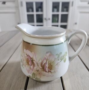 Vintage Bavarian creamer with pink roses and gold trim.